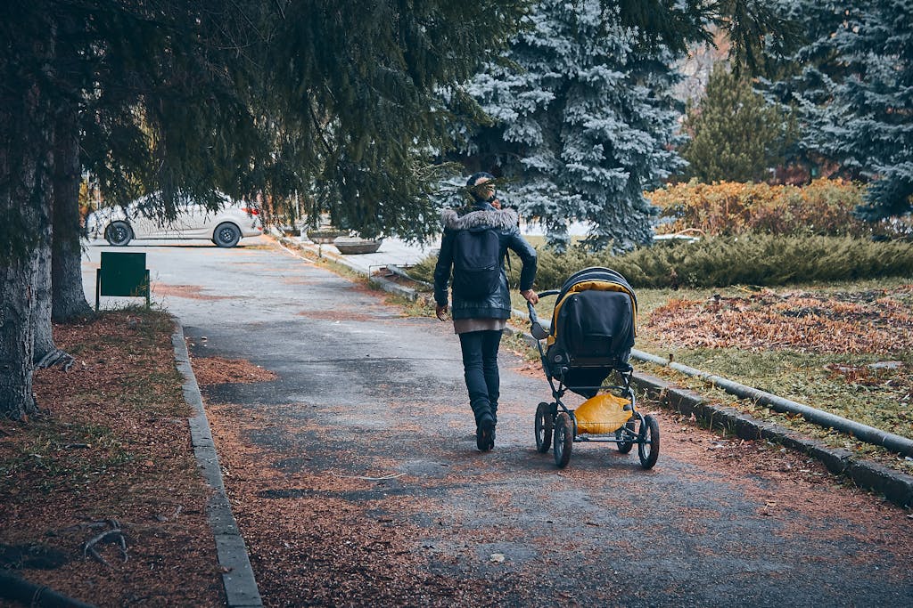 Tall parents pushing adjustable handle travel system stroller comfortably outdoors