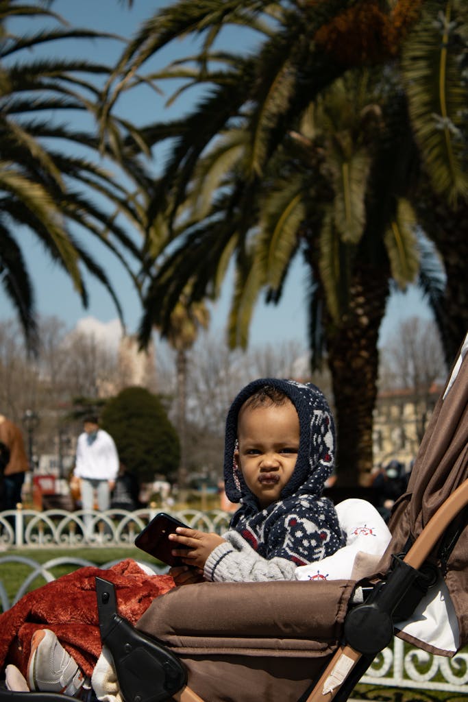 Parent traveling through airport with compact airline-approved baby stroller designed for airplane cabins ( best stroller for air travel)