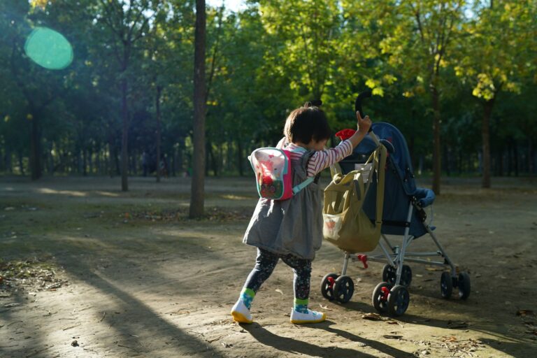 Parent walking with toddler showing when should a child stop using a stroller