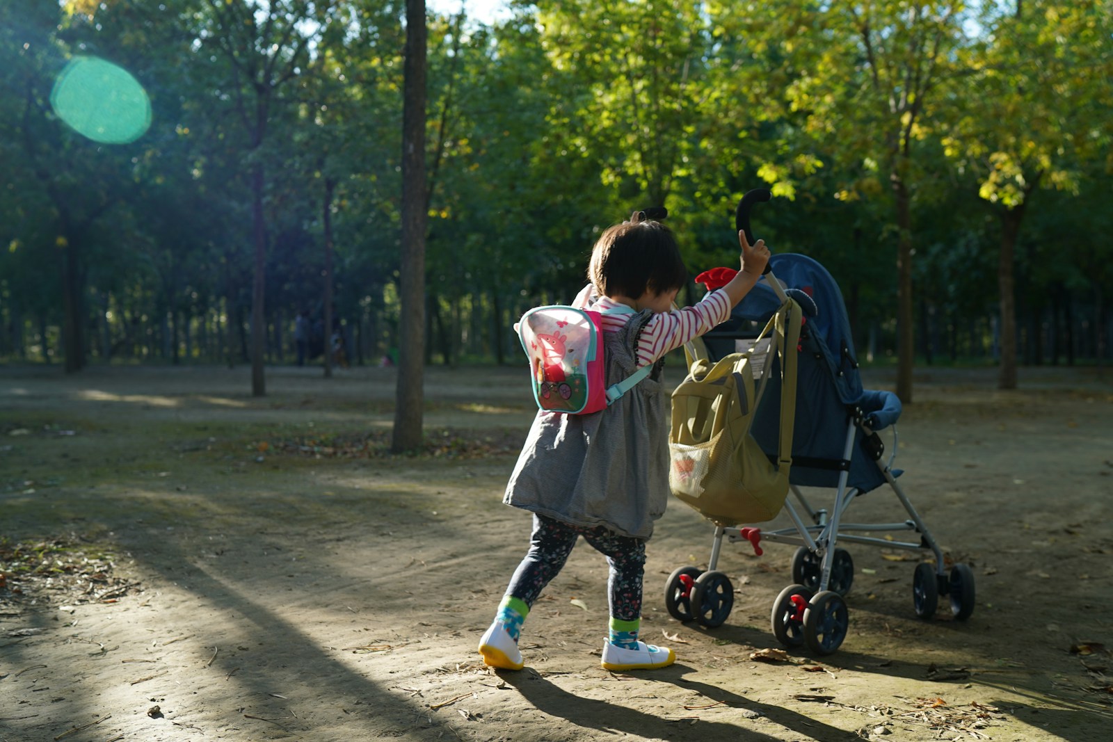 Parent walking with toddler showing when should a child stop using a stroller