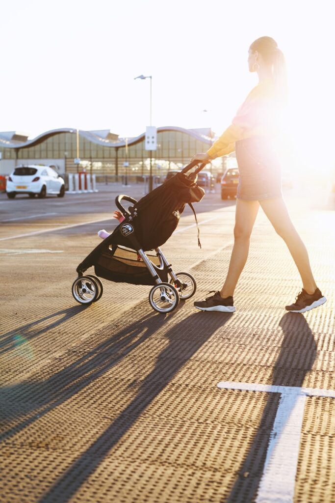 Parent pushing one of the best strollers for short parents with adjustable handlebar and infant car seat travel system.