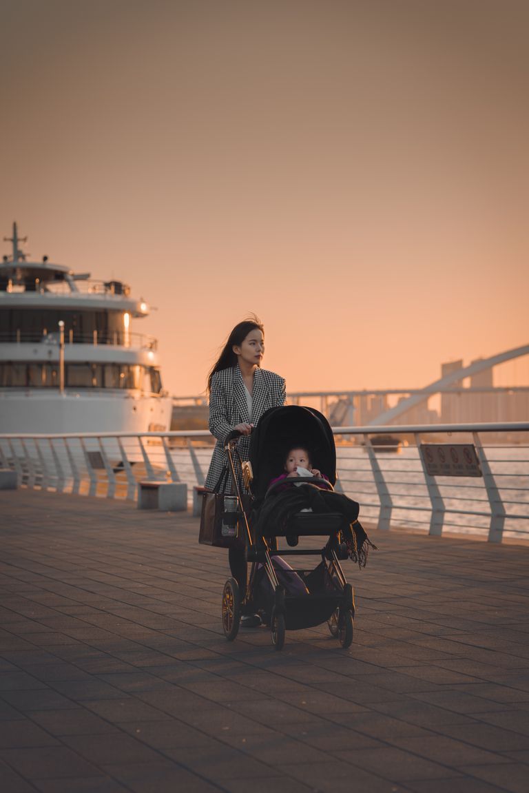 Best strollers for city living displayed on an urban sidewalk with parents walking through downtown.